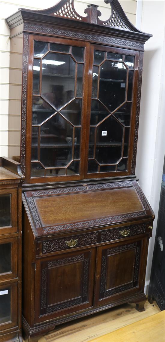 A 1920s blind fret carved mahogany bureau bookcase W.96cm